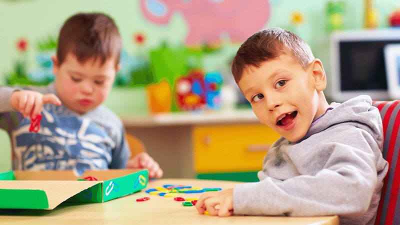 Children playing together, including a child with special needs